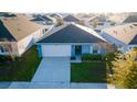 An aerial view showcases the home's roof, landscaping, and driveway within a suburban community at 751 Jefferson St, Davenport, FL 33837
