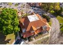 Aerial view of townhomes featuring red tile roofs, mature trees, and nearby parking at 8507 Waterview Way, Winter Haven, FL 33884