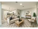 Cozy living room with modern furniture, open to dining area and kitchen, perfect for entertaining at 1013 Cannes Dr, Kissimmee, FL 34759