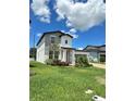 Two-story home with brick driveway, and manicured landscaping at 1220 Hilltop Pl # 1220, St Cloud, FL 34772