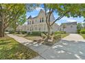 Charming two-story home with a inviting wraparound porch, turret, and lush landscaping at 1251 Aquila Loop, Celebration, FL 34747