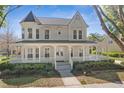 Charming two-story home with a inviting wraparound porch, turret, and manicured lawn at 1251 Aquila Loop, Celebration, FL 34747