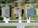 An aerial view showcases the property's layout and landscaping in a residential neighborhood at 1336 Lattimore Dr, Clermont, FL 34711