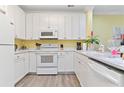 Bright kitchen featuring white cabinetry, modern appliances, and sleek countertops at 1370 Tuscana Ln # 5406, Davenport, FL 33896