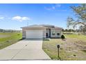 Attractive single-story house with a spacious driveway, lush lawn, and beautiful curb appeal at 139 Columbia Dr, Poinciana, FL 34759