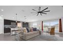 Bright living room featuring fan, modern furnishings, and large windows for natural light at 1431 Lassen St, Haines City, FL 33844