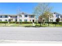 Street view showcasing a row of well-maintained townhomes and manicured lawns at 1615 Reflection Cv, St Cloud, FL 34771