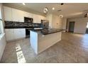 Modern kitchen featuring white cabinets, granite countertops, an island, and stainless steel appliances at 16180 Arbor Crest Aly, Winter Garden, FL 34787