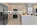 Bright kitchen featuring stainless steel appliances, modern cabinets, and a center island at 17220 Blessing Dr, Clermont, FL 34714