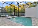 Relaxing screened-in spa featuring comfortable seating and a view of mature trees at 17220 Blessing Dr, Clermont, FL 34714