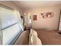 Bedroom features a glimpse of the bathroom, neutral walls, and a comfortable bed at 224 Montana Ave, St Cloud, FL 34769