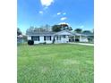 Charming single-story home with a well-maintained lawn, carport, and inviting front porch at 224 Montana Ave, St Cloud, FL 34769