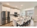 Modern kitchen boasts stainless steel appliances, granite countertops, and island seating at 2372 Sirena Ln, Mount Dora, FL 32757