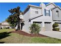 Charming townhome featuring a two-car garage, well-kept landscaping, and inviting front entry at 2515 Hassonite St, Kissimmee, FL 34744