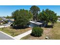 Exterior angle of a single story home featuring mature trees and walkway at 2601 Salina Way, Kissimmee, FL 34758