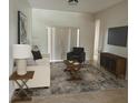 Bright living room showcasing stylish decor, a cozy armchair, and a large window for ample natural light at 2981 Winding Trl, Kissimmee, FL 34746