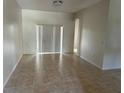 Spacious living area with neutral tile flooring and sliding glass doors to the exterior at 2981 Winding Trl, Kissimmee, FL 34746