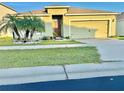 Charming single-story home featuring a well-manicured lawn and vibrant tropical landscaping at 3082 Royal Tern Dr, Winter Haven, FL 33881