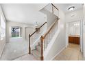 Bright foyer with staircase leading to an open-concept living space and neutral colors at 3102 Ashland N Ln # 3152, Kissimmee, FL 34741