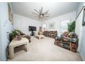 Bright and airy living room offers comfortable seating and a ceiling fan for added comfort at 466 Peppermill Cir, Kissimmee, FL 34758