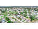 Aerial view of residential neighborhood with mature trees, homes with solar panels, and community streets at 509 Lakeview Dr, Poinciana, FL 34759