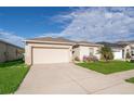 Well-kept lawn and garden highlight the home's exterior, along with an attached two car garage at 579 Lucerne Blvd, Winter Haven, FL 33881