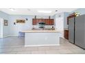 Open kitchen with center island, stainless steel appliances, and tile floors provides lots of space at 579 Lucerne Blvd, Winter Haven, FL 33881