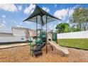 Community playground with a sunshade, slide, steps, and various play features, perfect for Gathering enjoyment at 812 Blue Creek Dr, Haines City, FL 33844