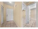 Bright entryway featuring tile floors, neutral walls, and doorways to the bathroom and another room at 86 Pine Island Cir, Kissimmee, FL 34743