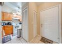 Inviting entryway with tiled floor, kitchen view, and closet for coat and storage at 86 Pine Island Cir, Kissimmee, FL 34743