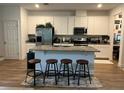 Well-equipped kitchen with granite countertops, modern appliances, and a spacious island at 9690 Emerald Berry Dr, Winter Garden, FL 34787