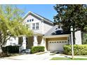 Inviting home with a manicured front lawn, a two-car garage, and a covered front porch at 1027 Banks Rose St, Celebration, FL 34747