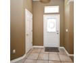 Inviting foyer with neutral colors, tile flooring, and a front door featuring decorative glass at 1027 Banks Rose St, Celebration, FL 34747