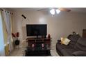 Comfortable living room features tile flooring, ceiling fan, and ample space for relaxation and entertainment at 1240 Sago Palm Blvd # 1240, Kissimmee, FL 34741