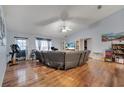 Spacious living room featuring vaulted ceilings, laminate floors and comfortable seating at 1437 Swift Ct, Kissimmee, FL 34759