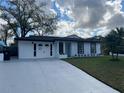 Beautifully remodeled white brick home with nice curb appeal and refreshed driveway at 1749 Sorolla Ct, Orlando, FL 32811