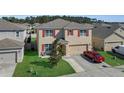 Well-maintained two-story home with an attached two-car garage and neat landscaping at 260 Willow Bend Dr, Davenport, FL 33897