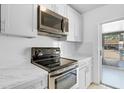 Bright kitchen with sleek, stainless steel appliances and ample counter space at 30 Las Palmas Way, Kissimmee, FL 34743