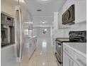 Well-equipped kitchen features stainless steel appliances and stone countertops at 30 Las Palmas Way, Kissimmee, FL 34743