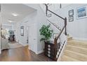 Spacious foyer with hardwood floors and a staircase leading to the upper level of the home at 3304 Cat Brier Trl, Harmony, FL 34773
