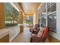 Inviting front porch featuring comfortable seating, decorative pillows, and a view of the surrounding neighborhood at 3304 Cat Brier Trl, Harmony, FL 34773