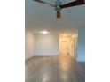 Open-concept living area with hardwood floors, ceiling fan and neutral walls at 3555 Rodrick Cir, Orlando, FL 32824