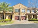 Charming two-story townhome with attached garage and a well-maintained front yard at 3655 Zuma Way, Orlando, FL 32839