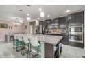 A large kitchen island features seating and overlooks the adjacent breakfast bar at 3705 Apopka Ridge Cir, Apopka, FL 32703
