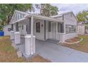 Street view of home featuring a covered carport, secure front door, and classic siding at 406 10Th St, St Cloud, FL 34769
