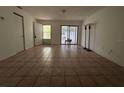 Spacious living room with tile flooring and access to the outdoor patio at 4179 Spitfire Ave, Kissimmee, FL 34741