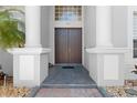 Elegant front entrance with double doors, stately columns, and decorative stonework for a grand welcome at 478 Chelsea Ave, Davenport, FL 33837