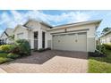 Attractive single-story home with a brick paver driveway and a well-maintained two-car garage at 5151 Twin Lakes Blvd, St Cloud, FL 34772