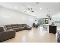 Spacious living room boasts tile floors, modern furniture, and an open-concept layout with a dining area at 5151 Twin Lakes Blvd, St Cloud, FL 34772