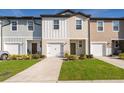 Charming townhomes with colorful facades, well-maintained lawns, and driveways leading to attached garages at 728 Madison Dr, Davenport, FL 33837
